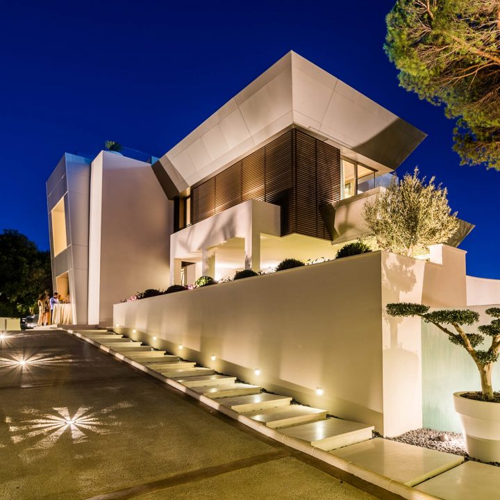 Villa Silver, lit entrance path and angular volumes at night